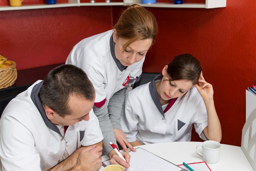 nurse instructs other employees in the break room