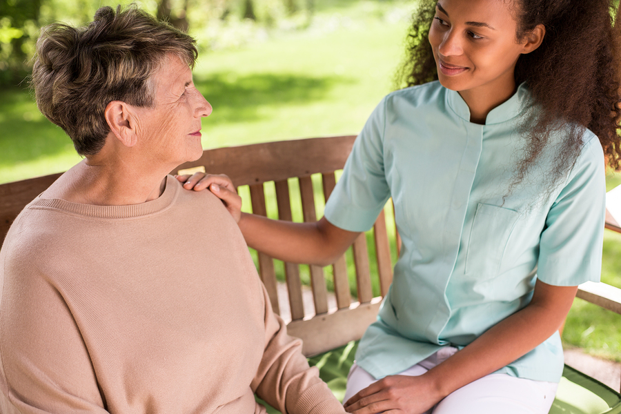 Senior woman and carer spending time outside